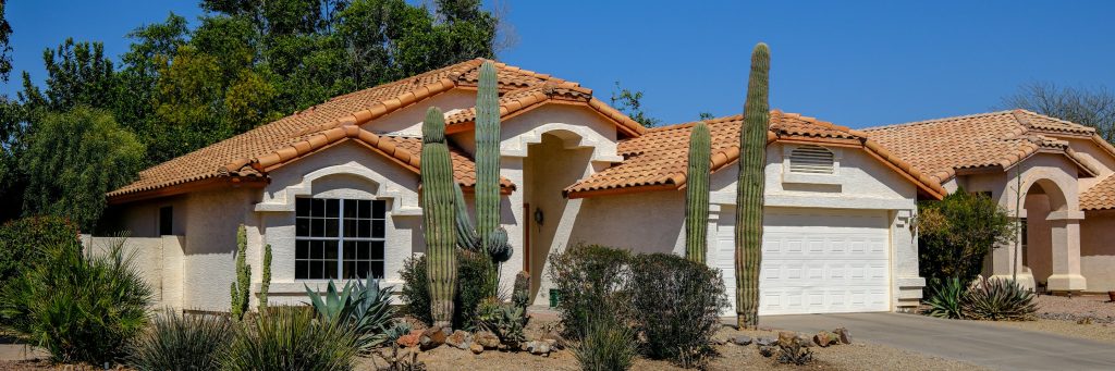 A stucco home with a sectional garage door
