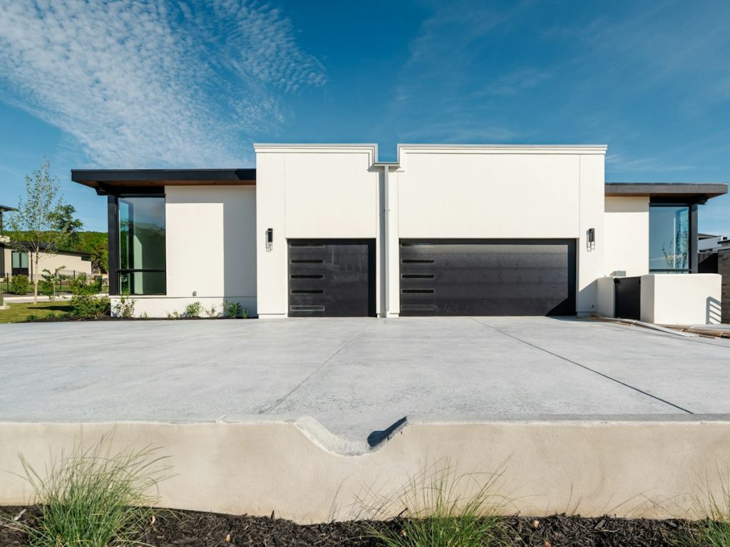 A home with two dark sectional garage doors